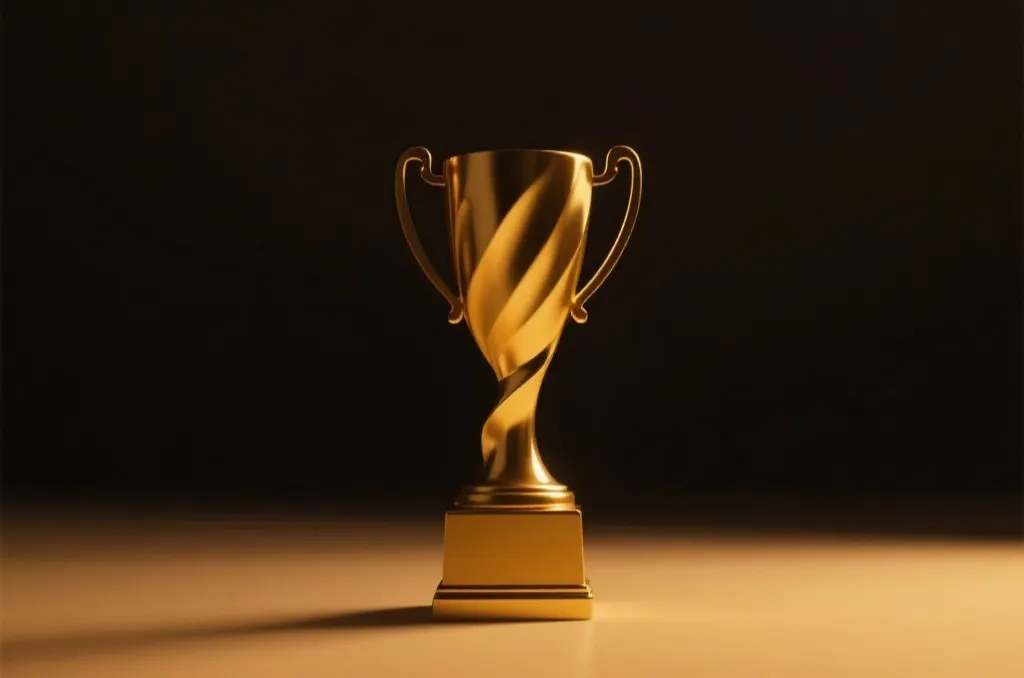 A golden abstract victory trophy silhouette with warm studio lighting and minimalist dark background